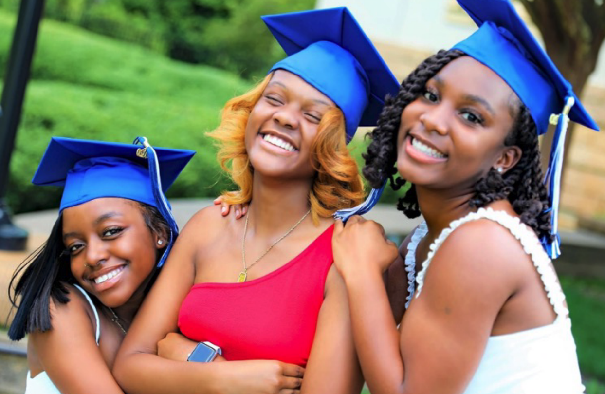Three students wearing graduation caps