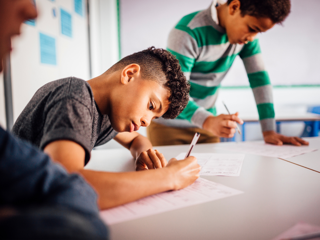 Student working hard on an assignment at desk