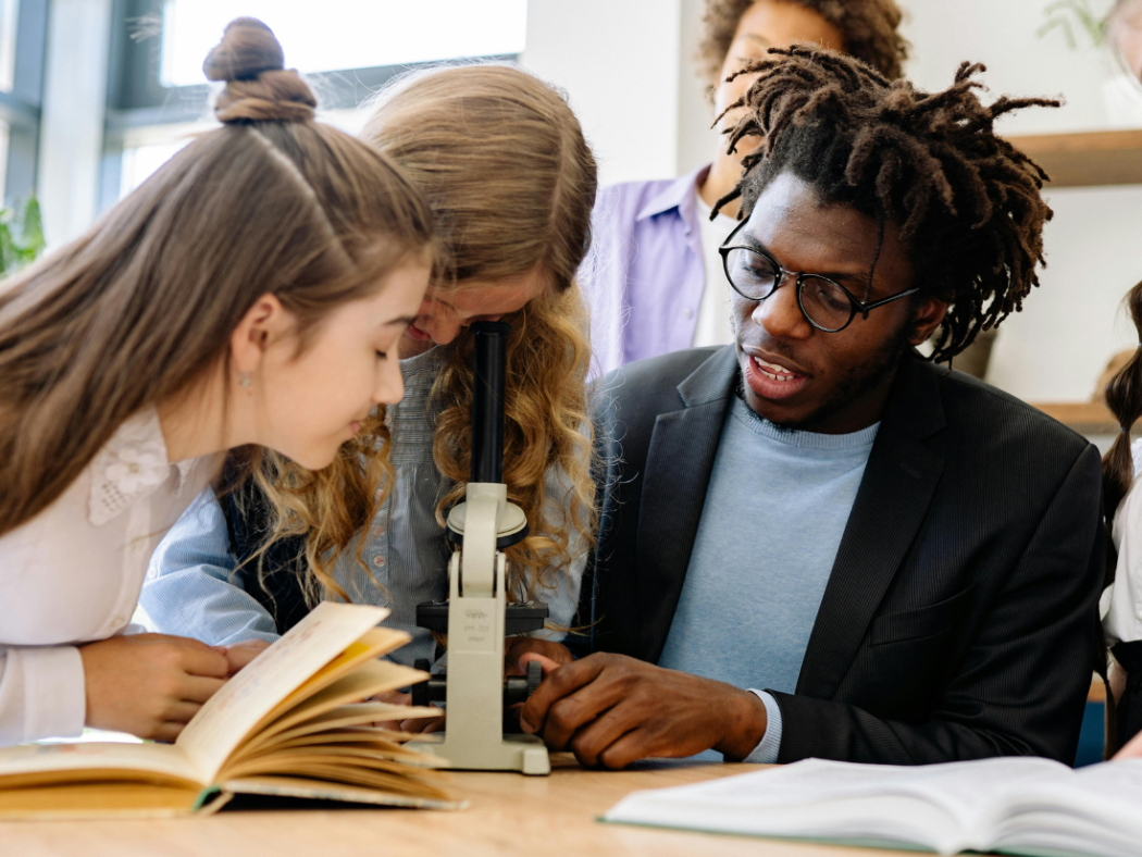 New teacher working with students on a science project