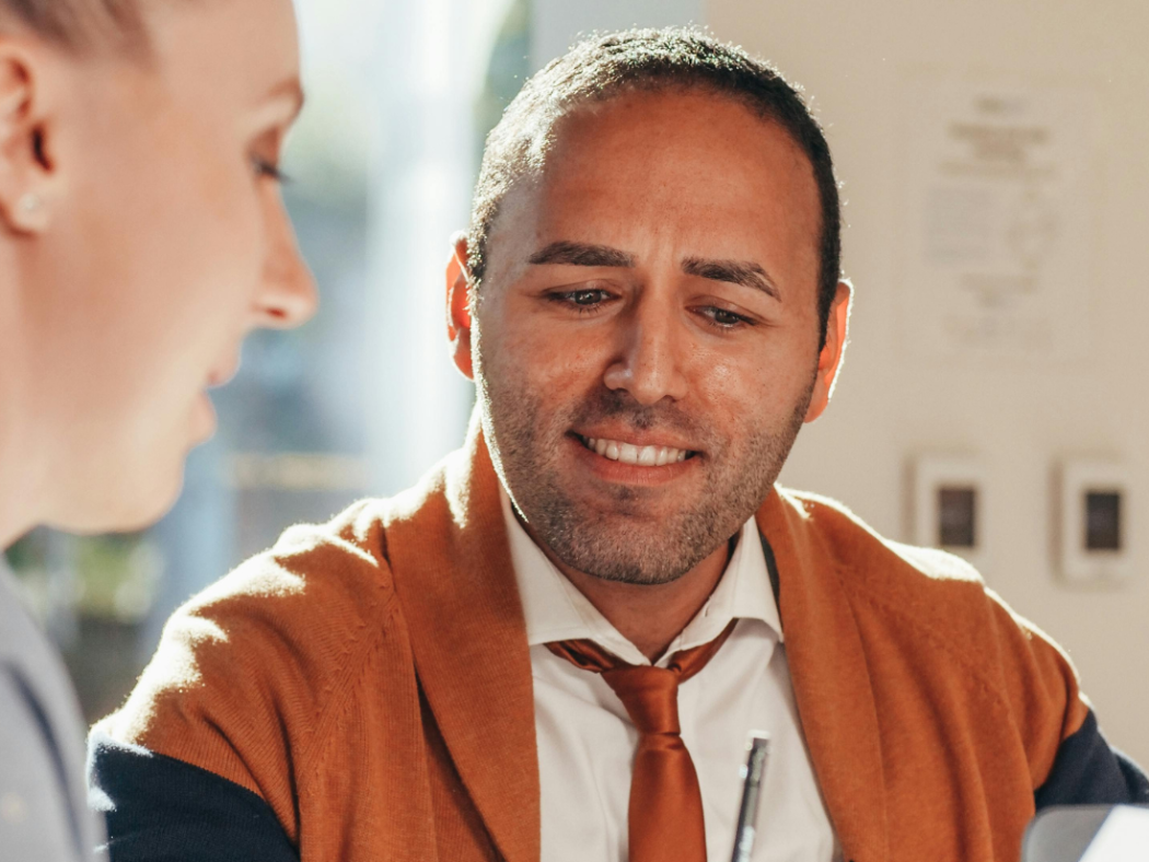 Veteran mentor working with a young teacher