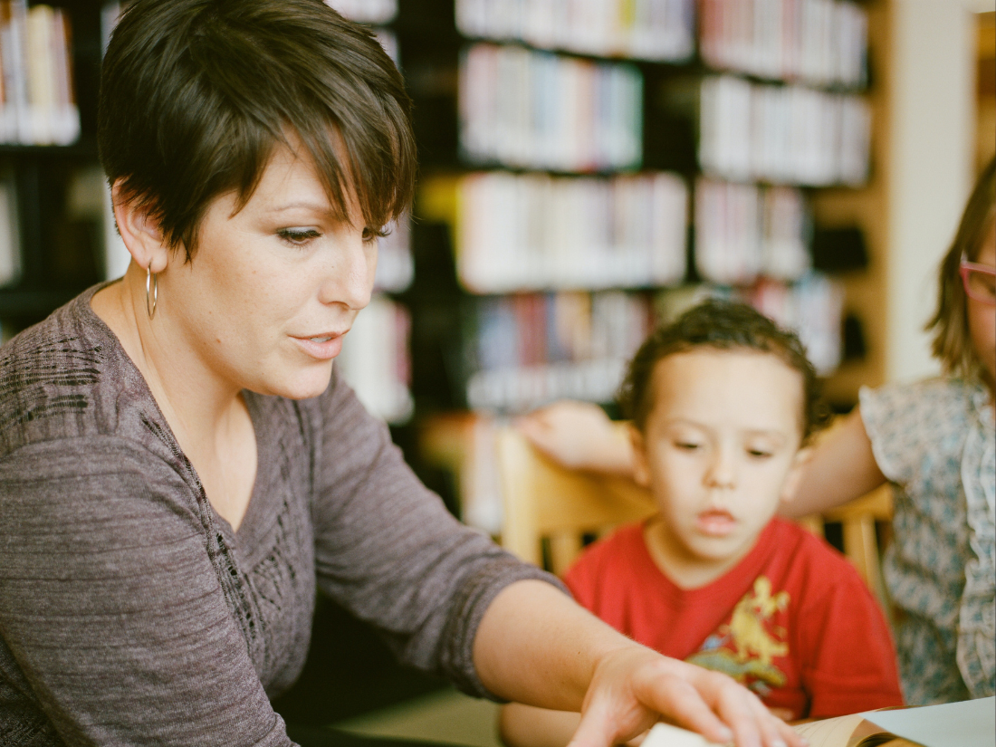 Teacher working on reading with young student