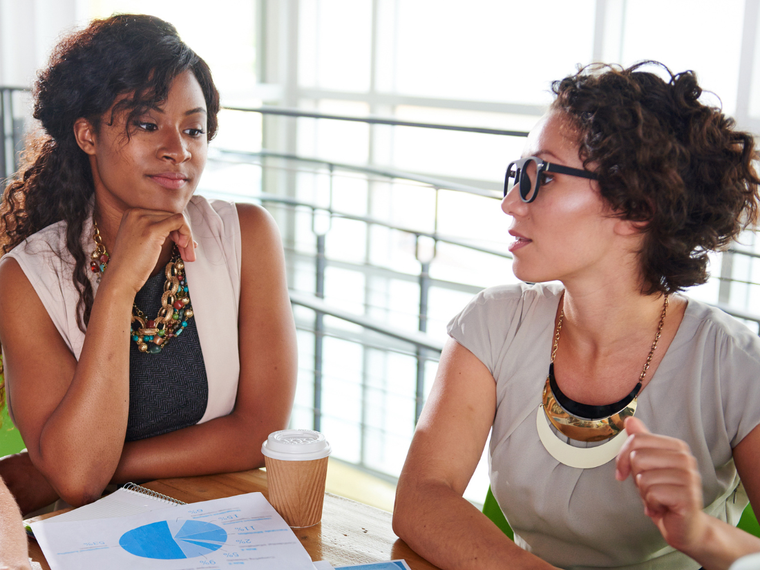 Two educators discussing work plans