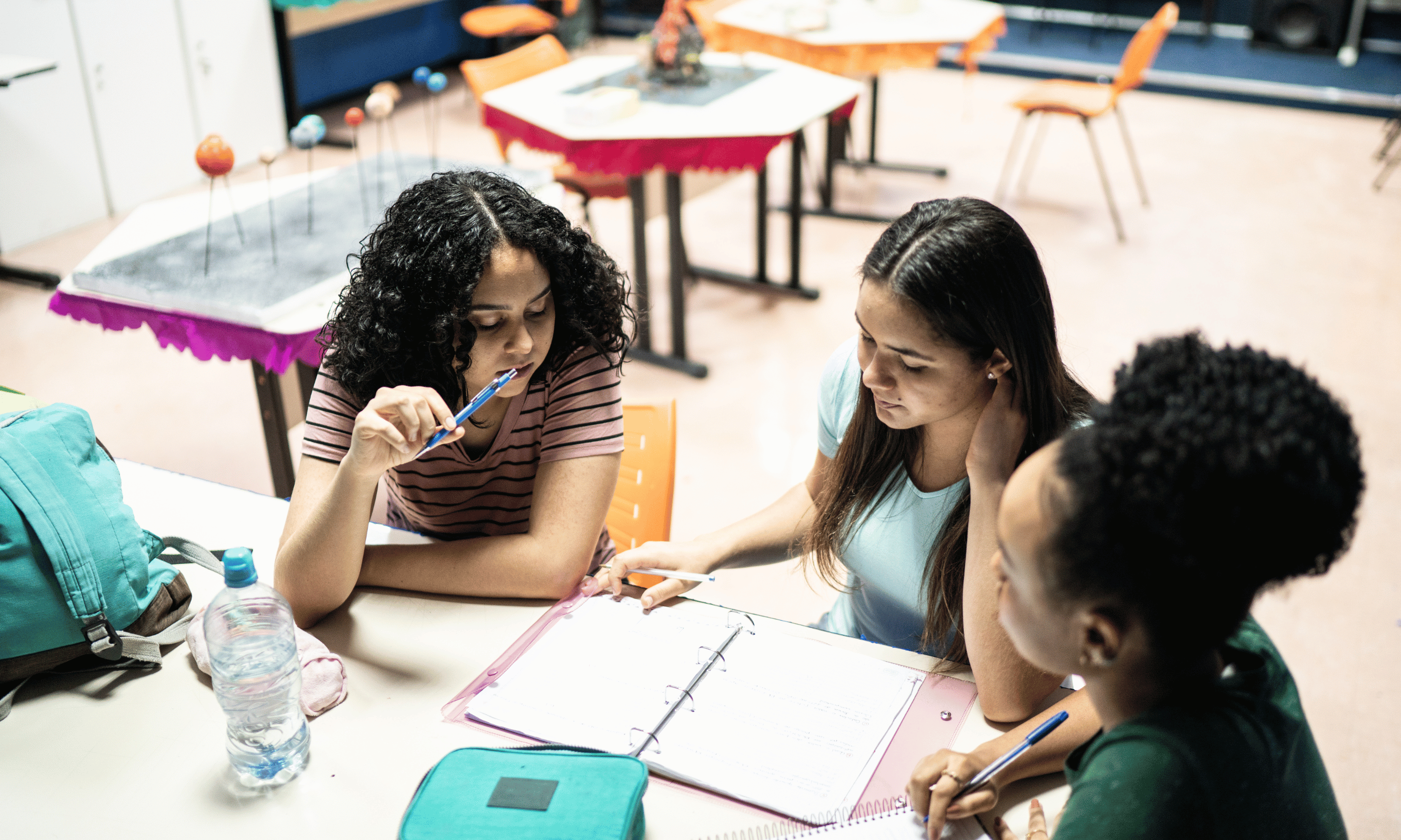 Group of students working around the table on an assignment