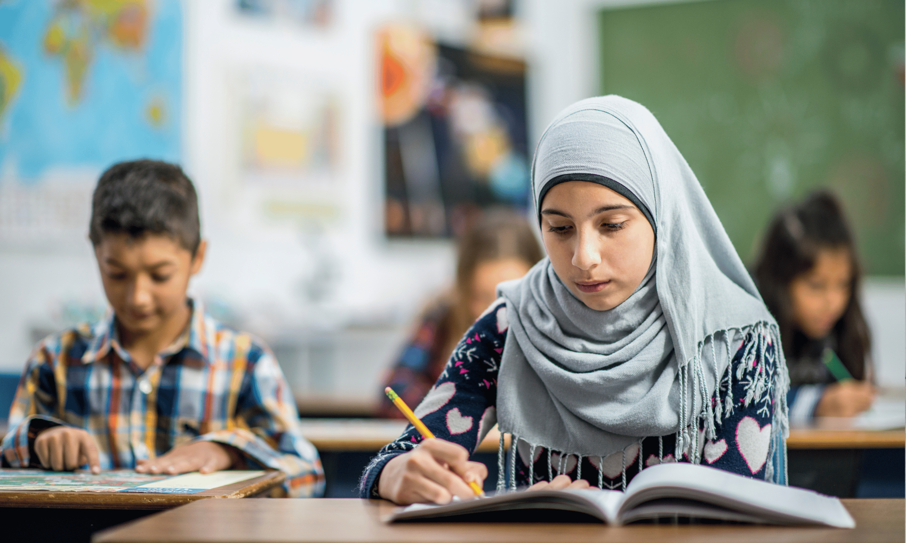 Group of diverse middle school students working on a class assignment