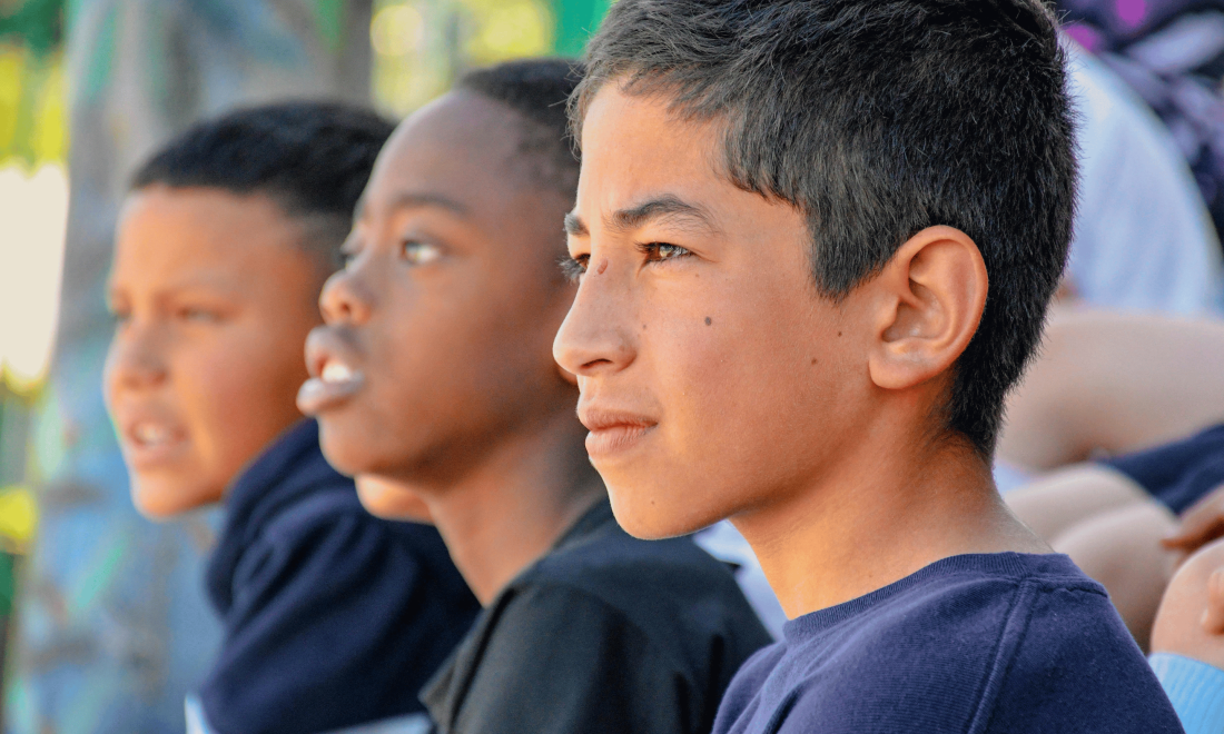 Group of Latino boys at school assembly