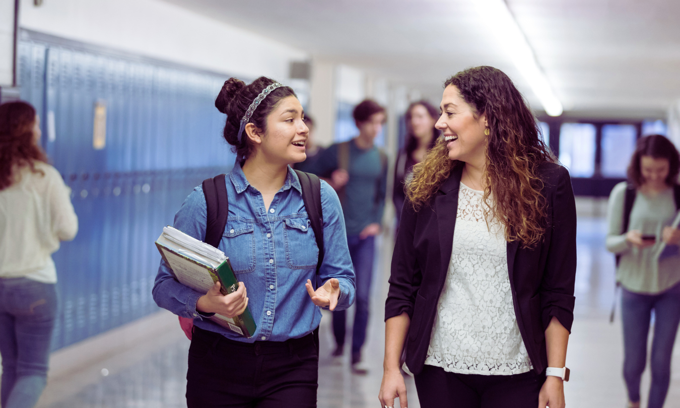 Student and teacher walking down hall